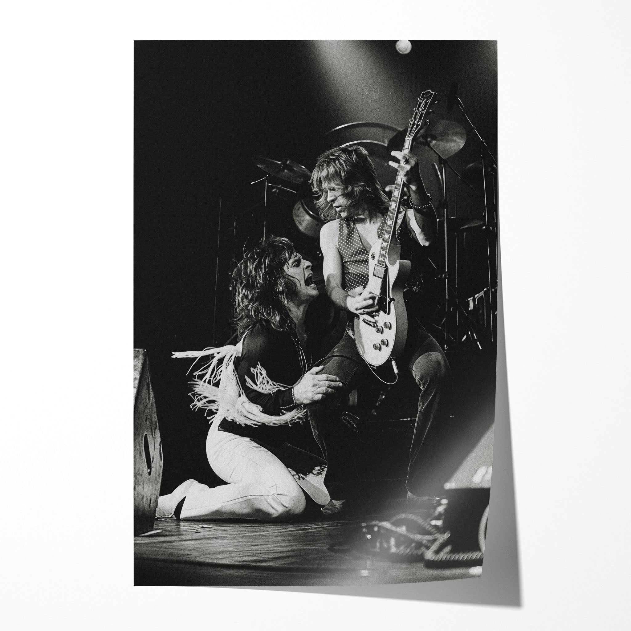 Unframed black and white print of Ozzy Osbourne kneeling before Randy Rhoads, Bradford 1980