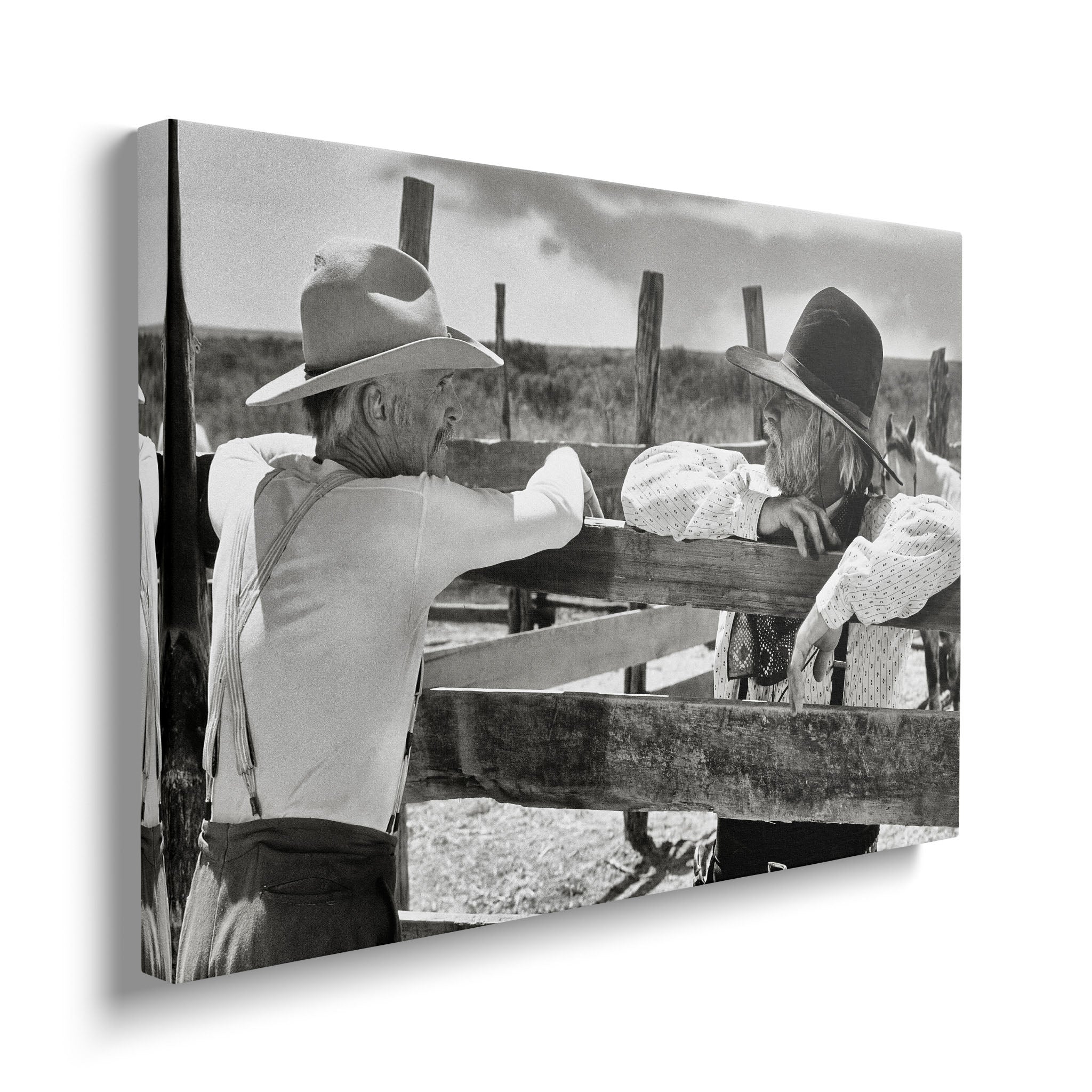 Gallery-wrapped black and white canvas of Gus and Call at the Hat Creek fence displayed on a wall