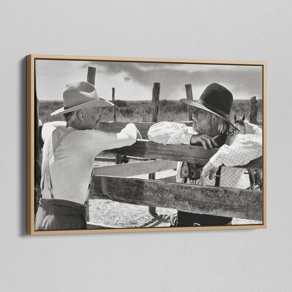 Angled view of the Lonesome Dove Hat Creek black and white canvas in a natural oak floating frame