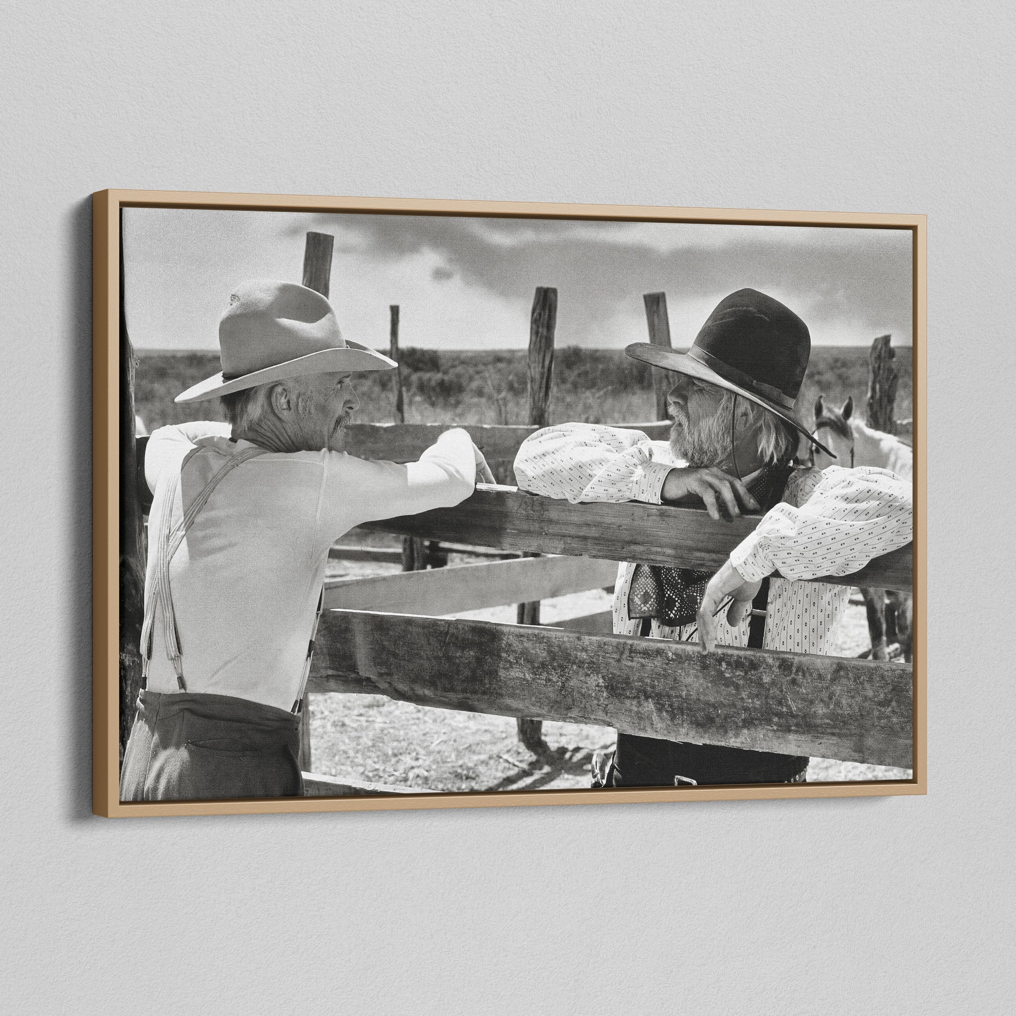 Angled view of the Lonesome Dove Hat Creek black and white canvas in a natural oak floating frame