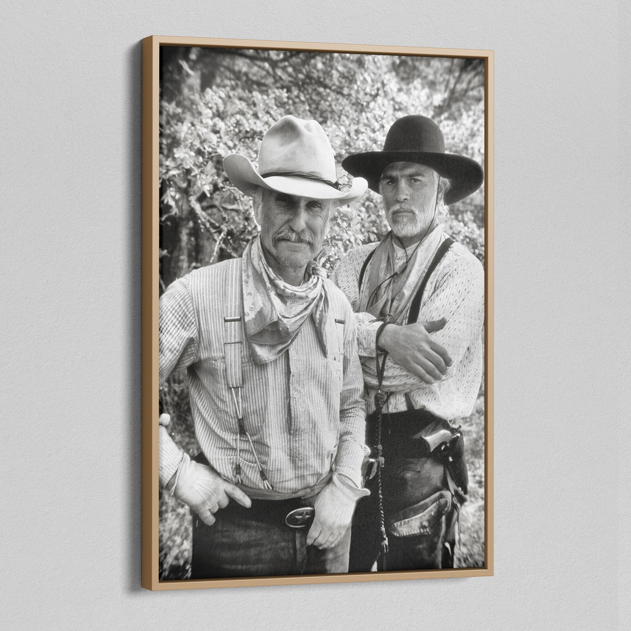 Angled view of the Lonesome Dove black and white canvas in a natural oak floating frame