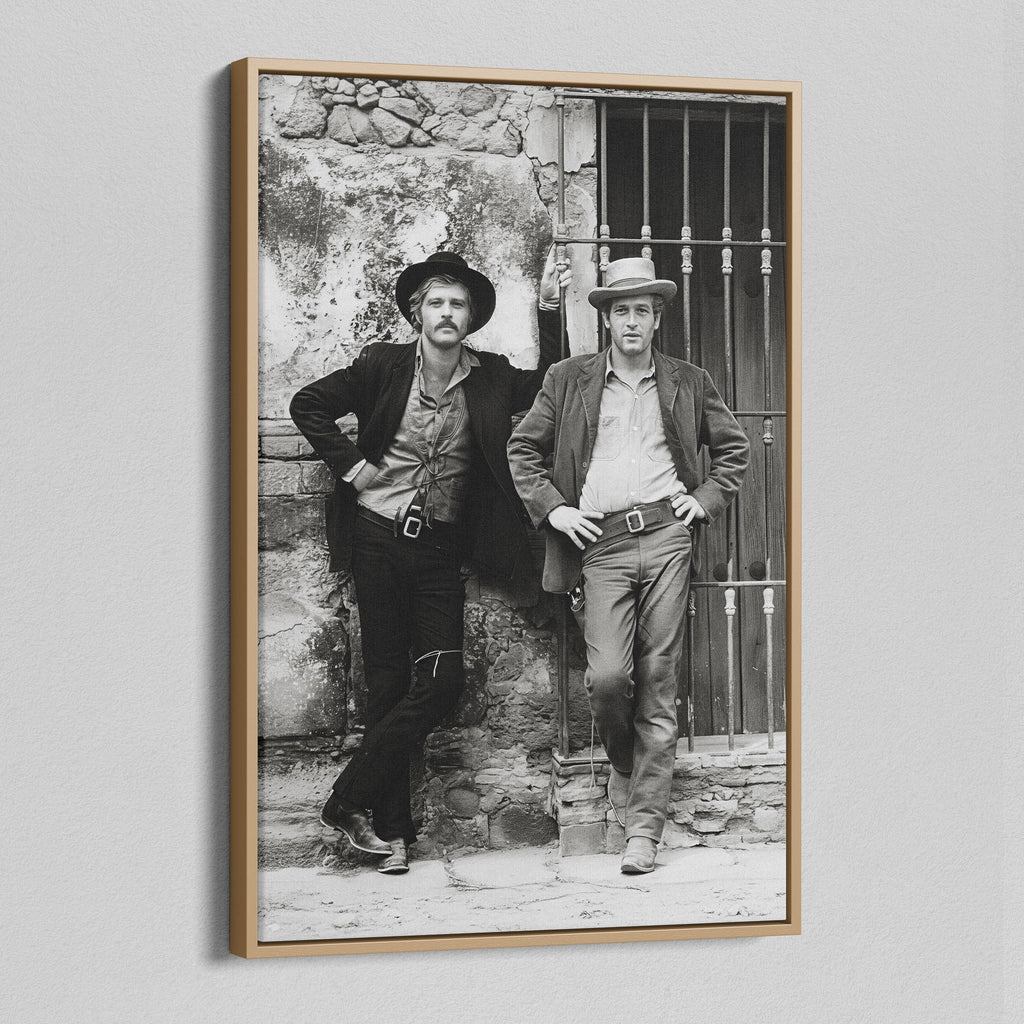 Angled view of the Butch Cassidy and the Sundance Kid black and white canvas in a natural oak floating frame