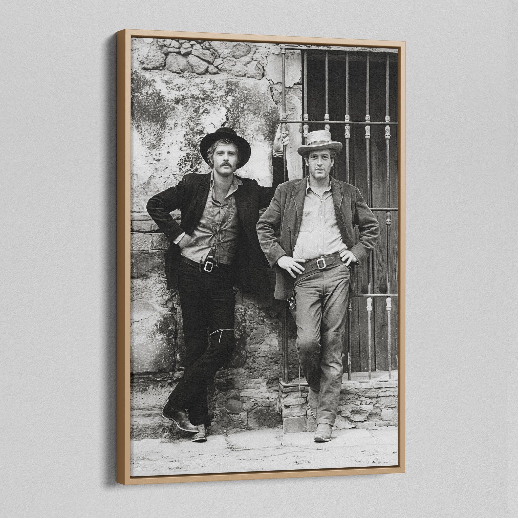 Angled view of the Butch Cassidy and the Sundance Kid black and white canvas in a natural oak floating frame