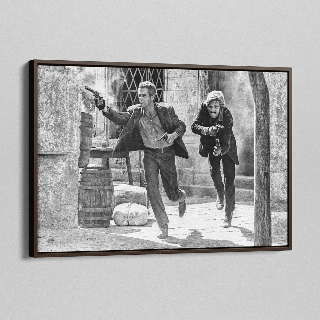 Angled view of the Butch Cassidy and the Sundance Kid final shootout black and white canvas in a dark walnut floating frame