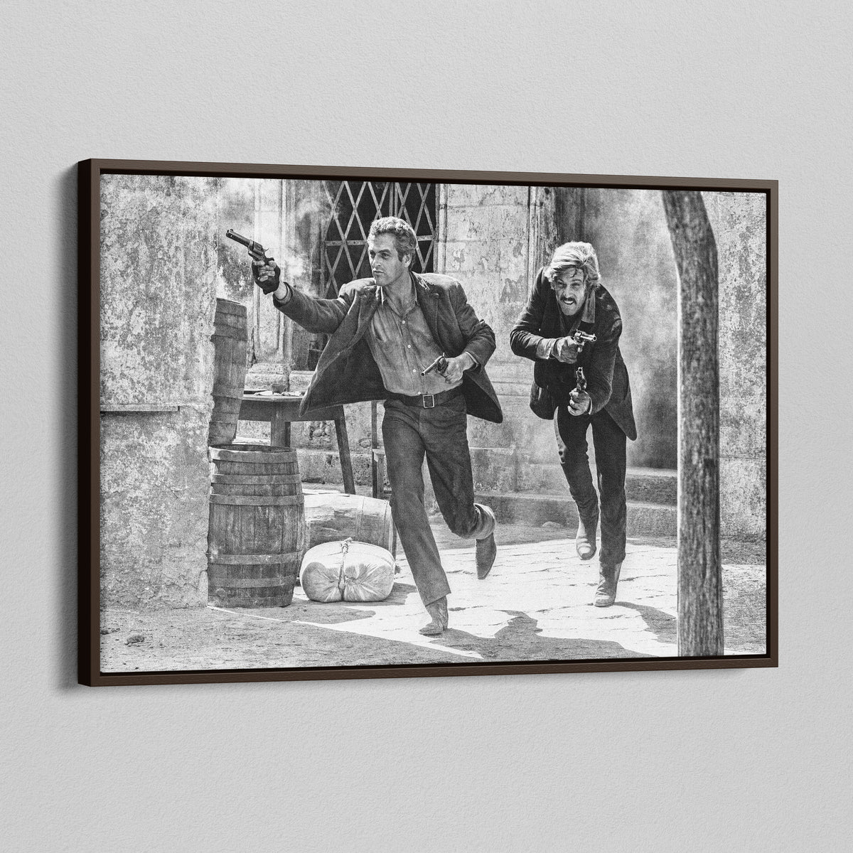 Angled view of the Butch Cassidy and the Sundance Kid final shootout black and white canvas in a dark walnut floating frame