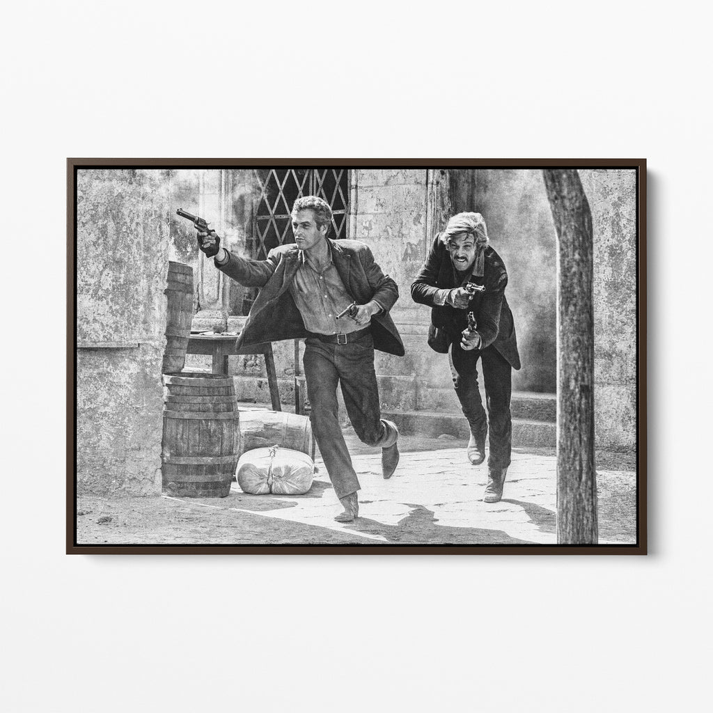 Front display of the Butch Cassidy and the Sundance Kid final shootout black and white canvas in a dark walnut floating frame