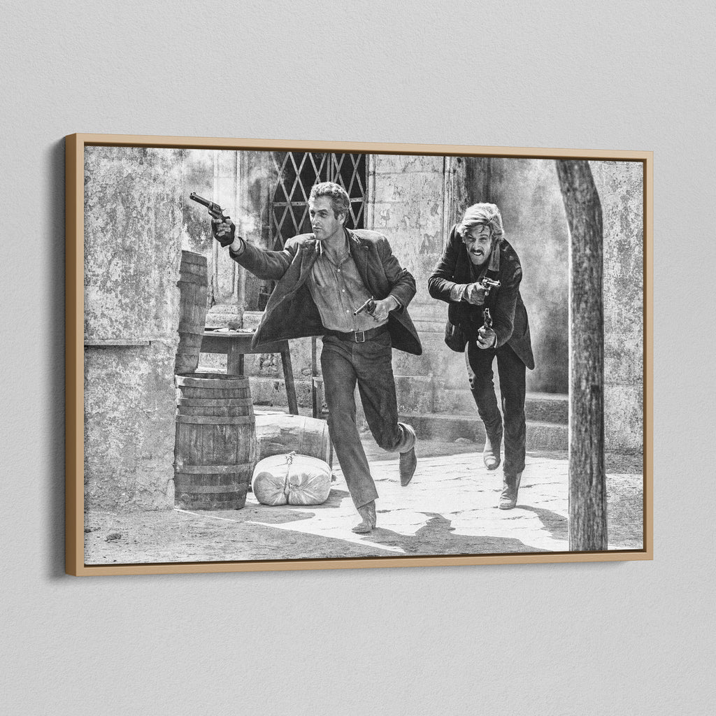 Angled view of the Butch Cassidy and the Sundance Kid final shootout black and white canvas in a natural oak floating frame