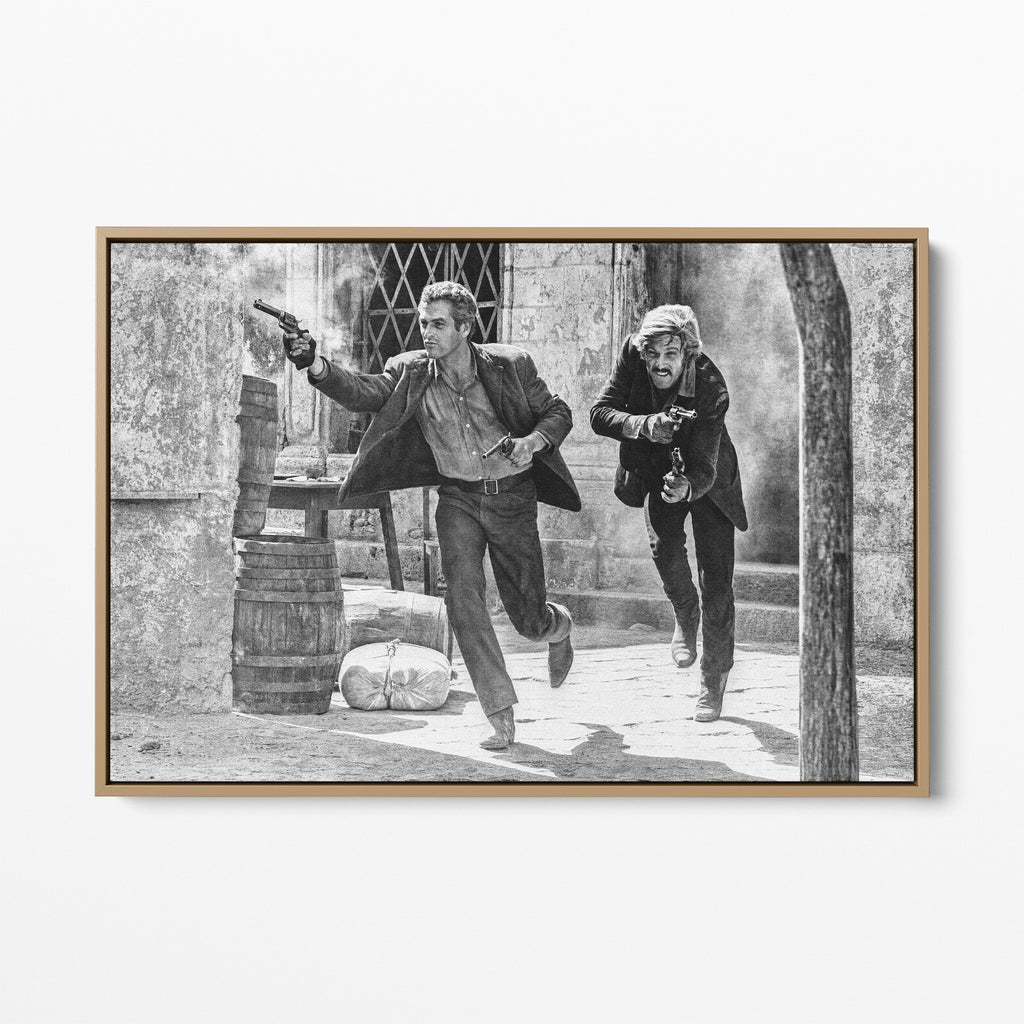 Front display of the Butch Cassidy and the Sundance Kid final shootout black and white canvas in a natural oak floating frame