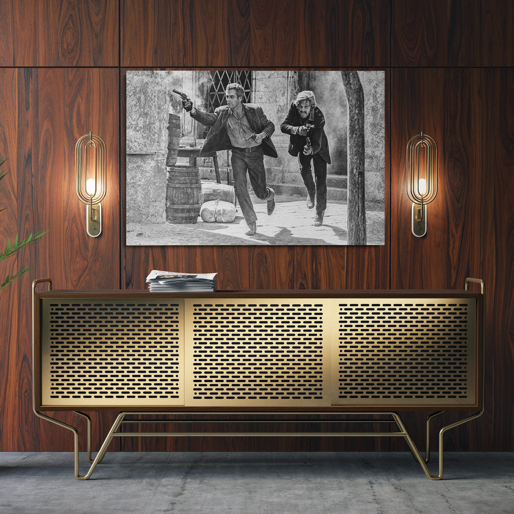 Sleek aluminum black and white metal print of the Butch Cassidy and the Sundance Kid final shootout above a sideboard