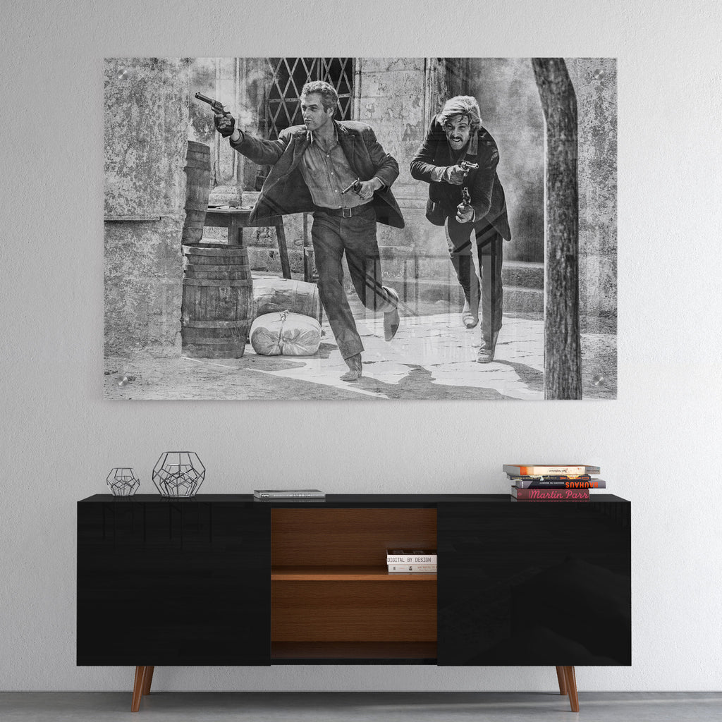 High-gloss acrylic black and white print of the Butch Cassidy and the Sundance Kid final shootout displayed on a wall