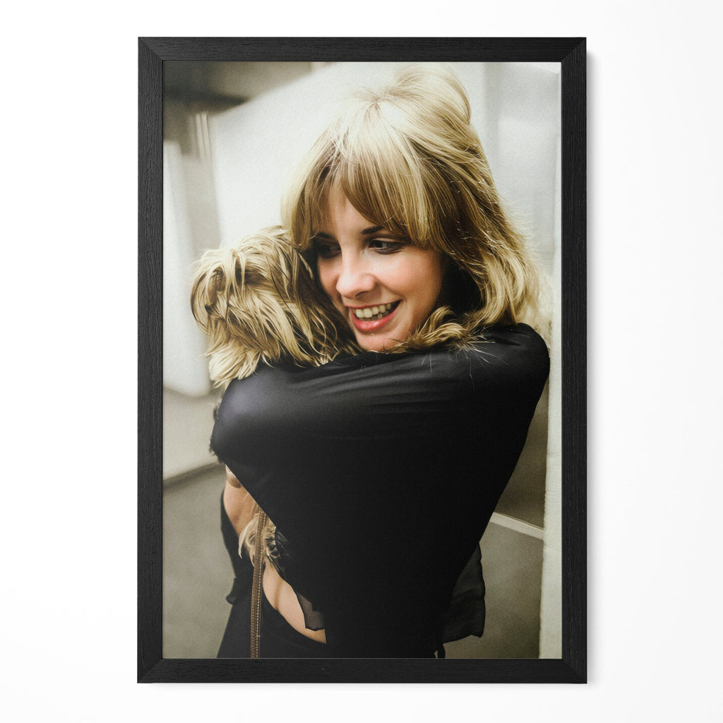 Stevie Nicks candid colour portrait cuddling her dog in a classic black poster frame