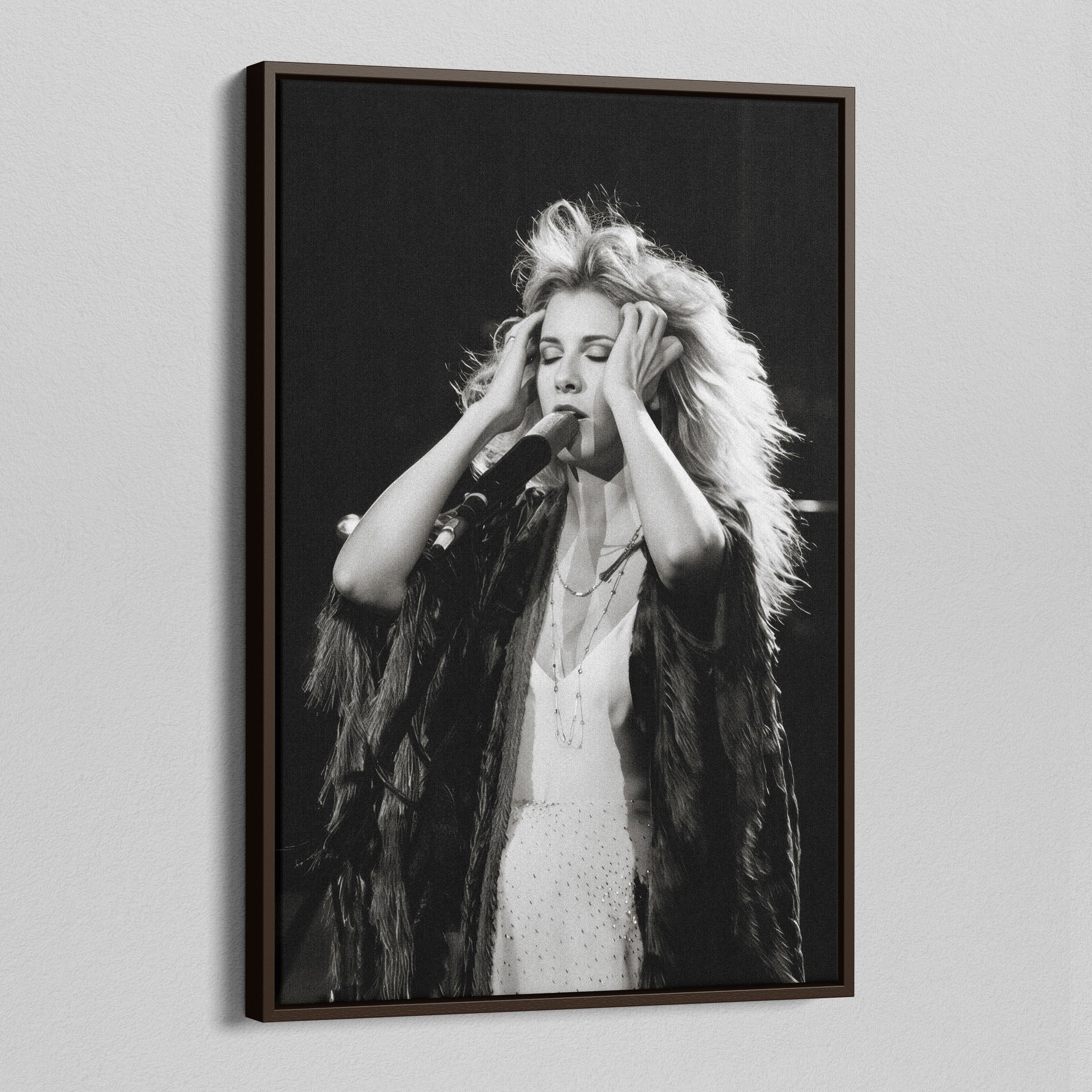 Angled view of the Stevie Nicks 1970s live black and white canvas in a dark walnut floating frame