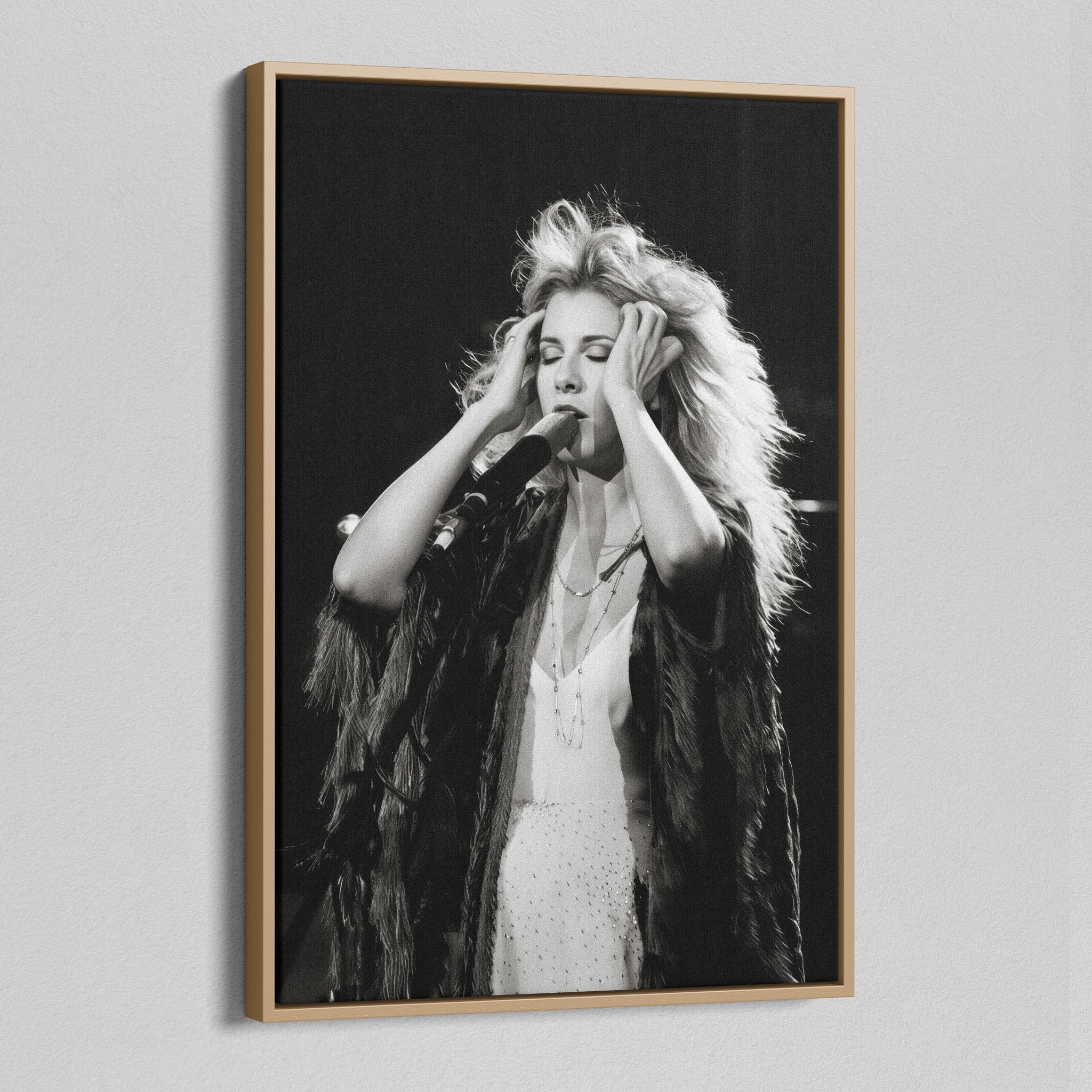Angled view of the Stevie Nicks 1970s live black and white canvas in a natural oak floating frame