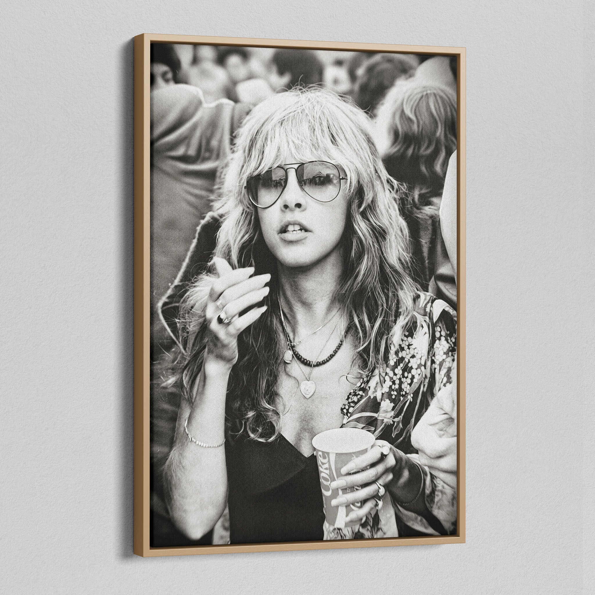 Angled view of the Stevie Nicks 1979 Tusk Tour black and white canvas in a natural oak floating frame