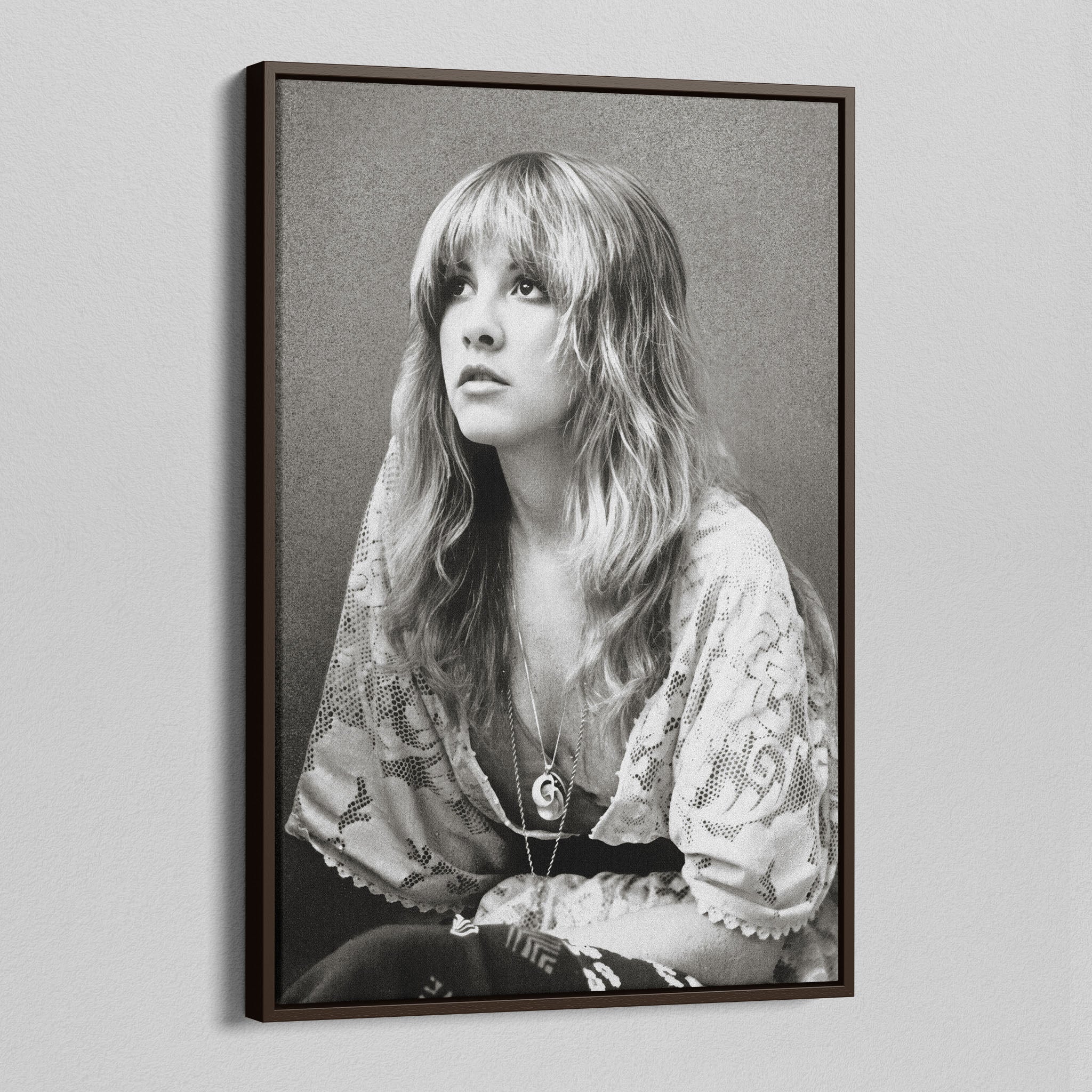 Angled view of the Stevie Nicks 1976 black and white portrait canvas in a dark walnut floating frame