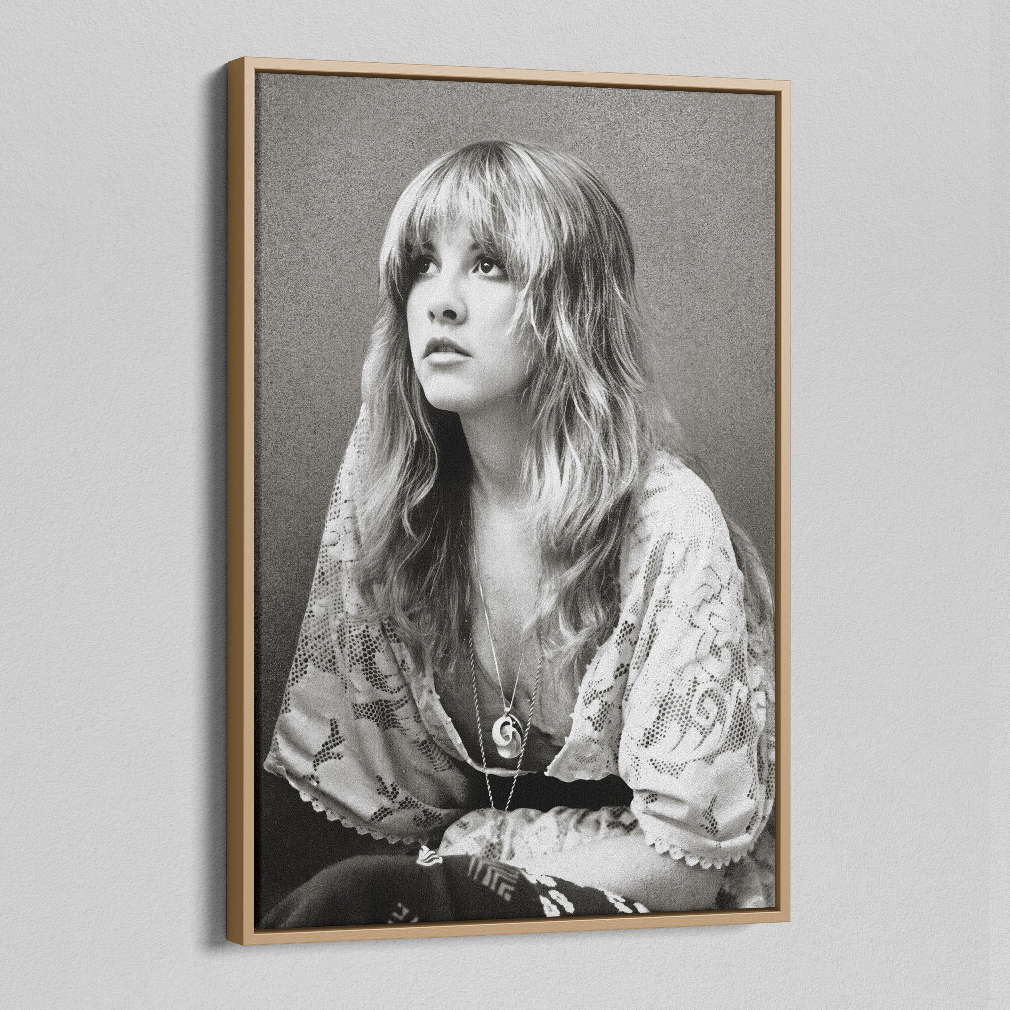Angled view of the Stevie Nicks 1976 black and white portrait canvas in a natural oak floating frame