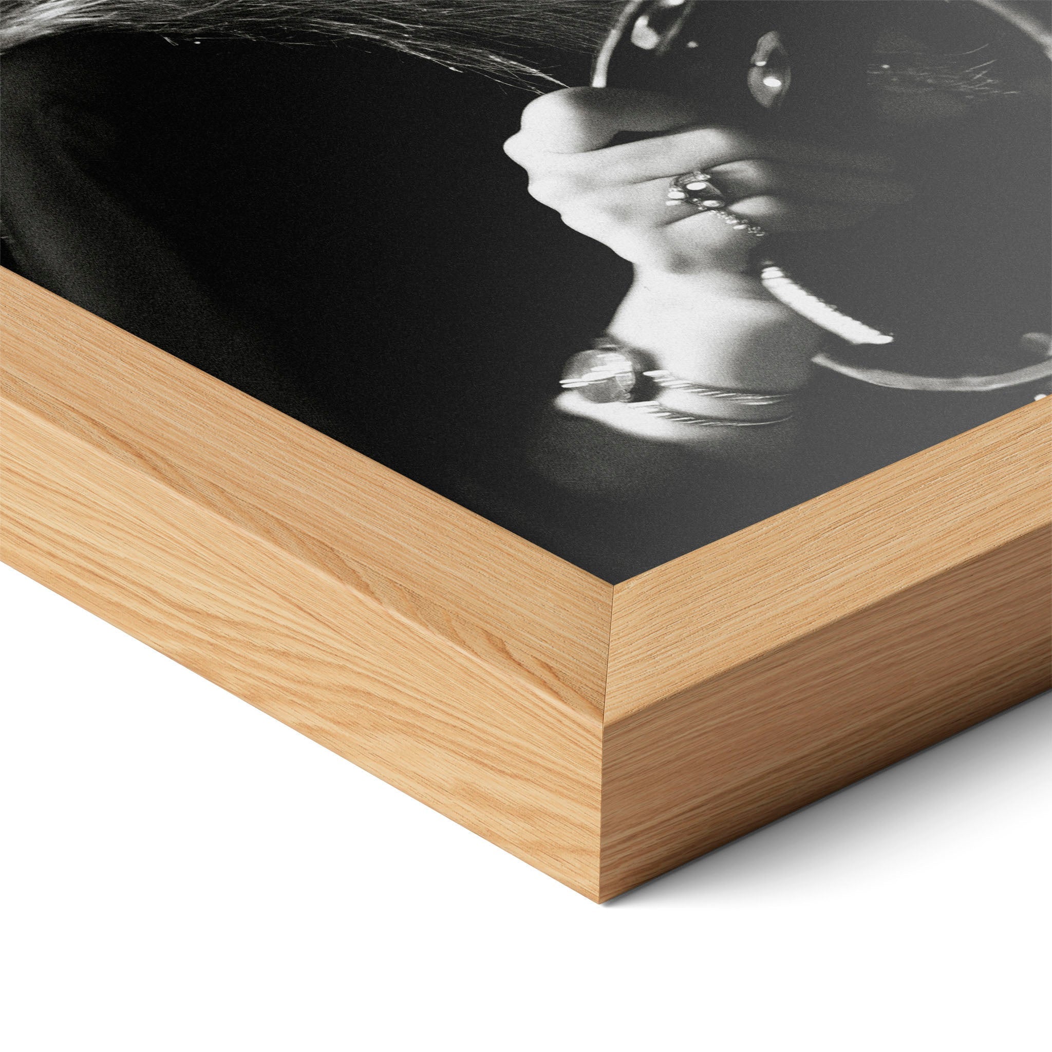 Corner close-up of the Stevie Nicks 1977 Oakland black and white poster in a natural oak frame