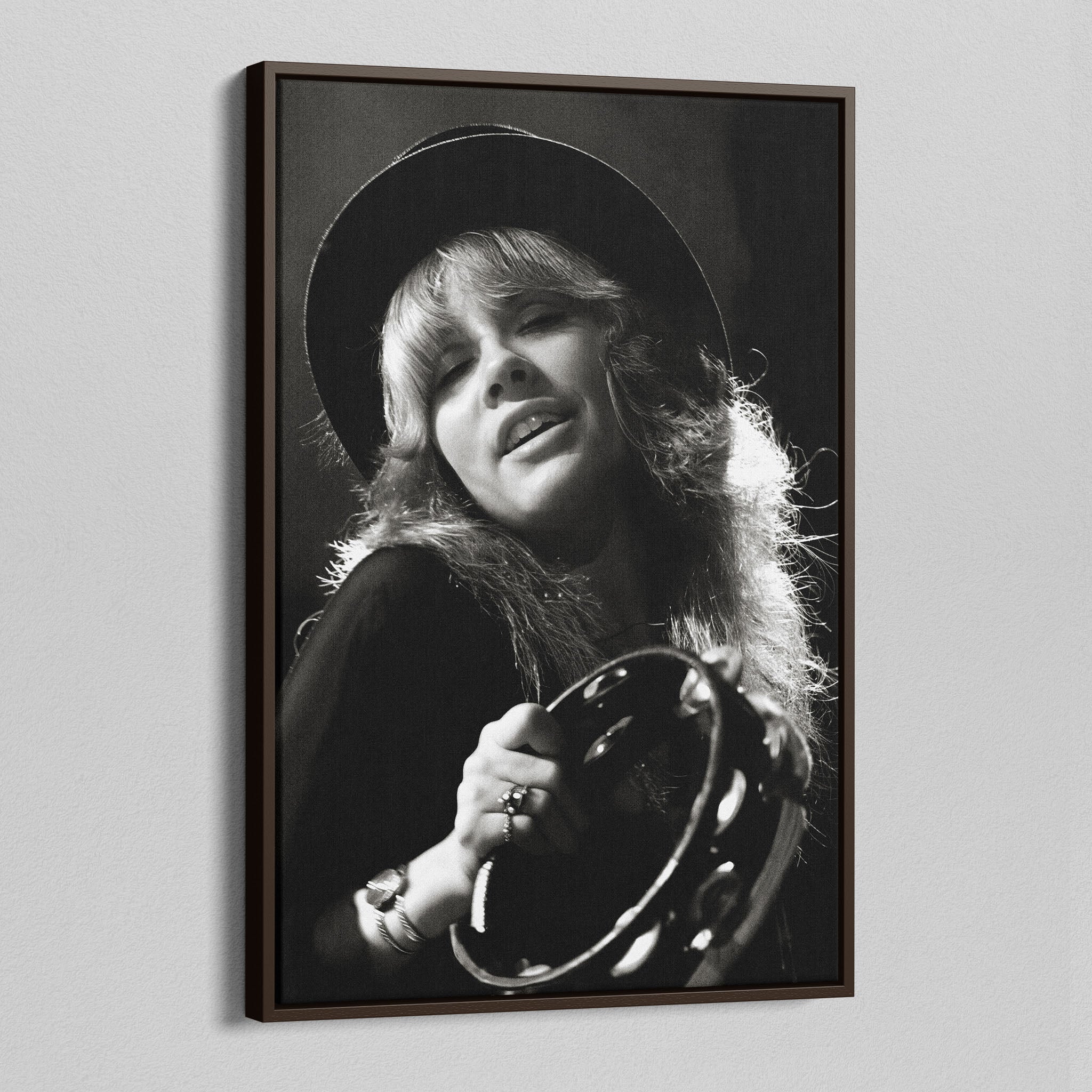 Angled view of the Stevie Nicks 1977 Oakland black and white canvas in a dark walnut floating frame