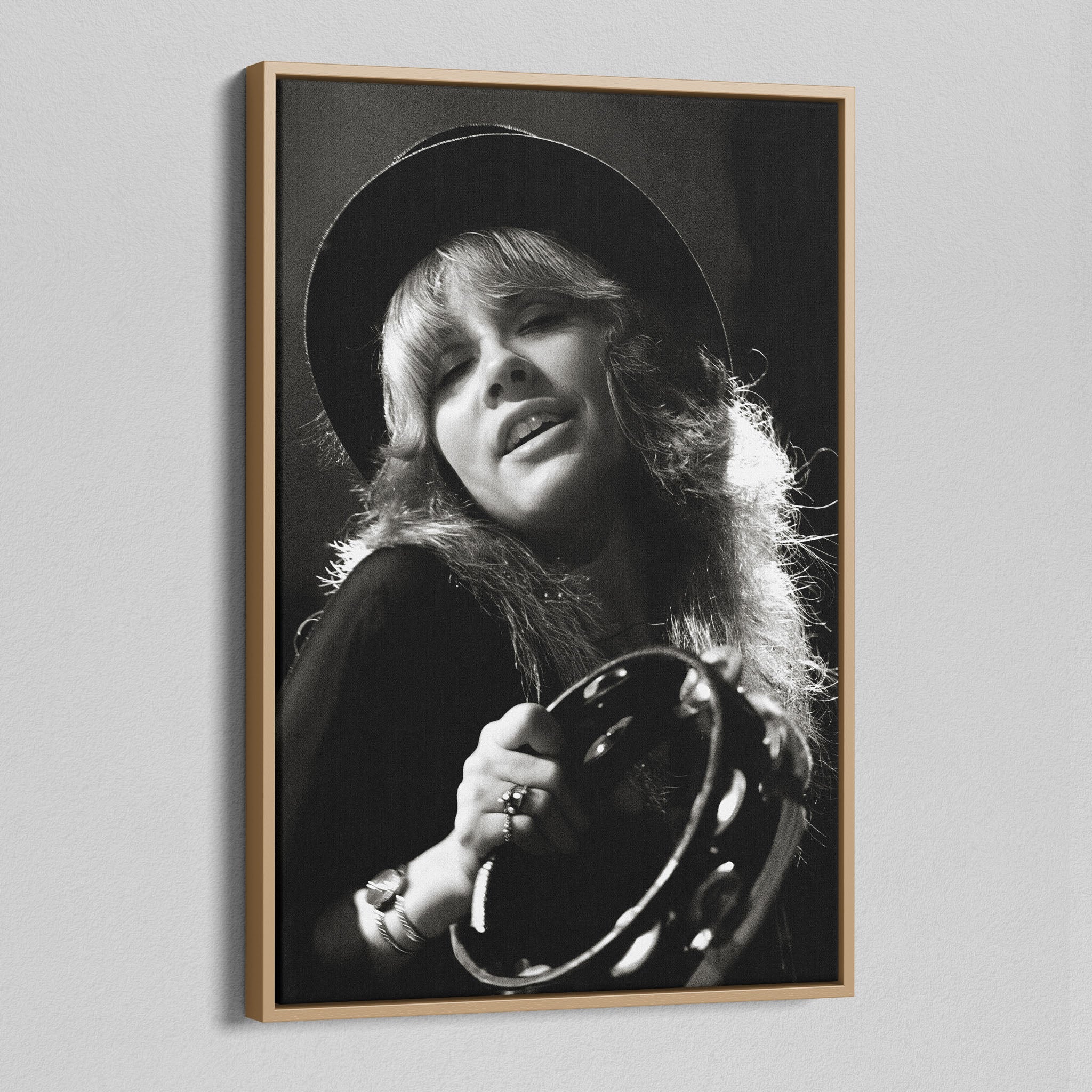 Angled view of the Stevie Nicks 1977 Oakland black and white canvas in a natural oak floating frame