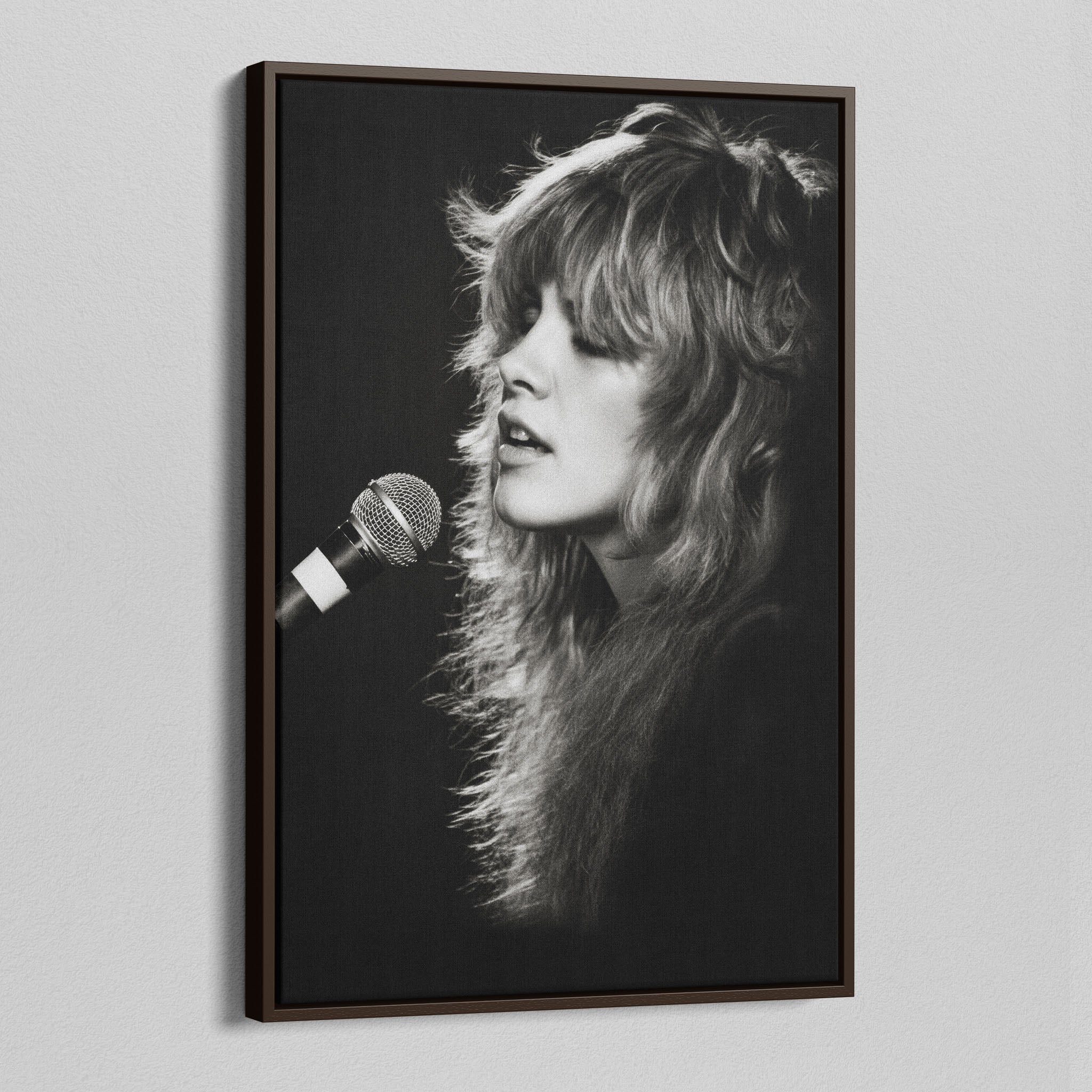 Angled view of the Stevie Nicks Rumours era black and white canvas in a dark walnut floating frame