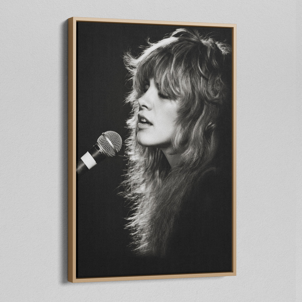 Angled view of the Stevie Nicks Rumours era black and white canvas in a natural oak floating frame