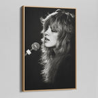 Angled view of the Stevie Nicks Rumours era black and white canvas in a natural oak floating frame