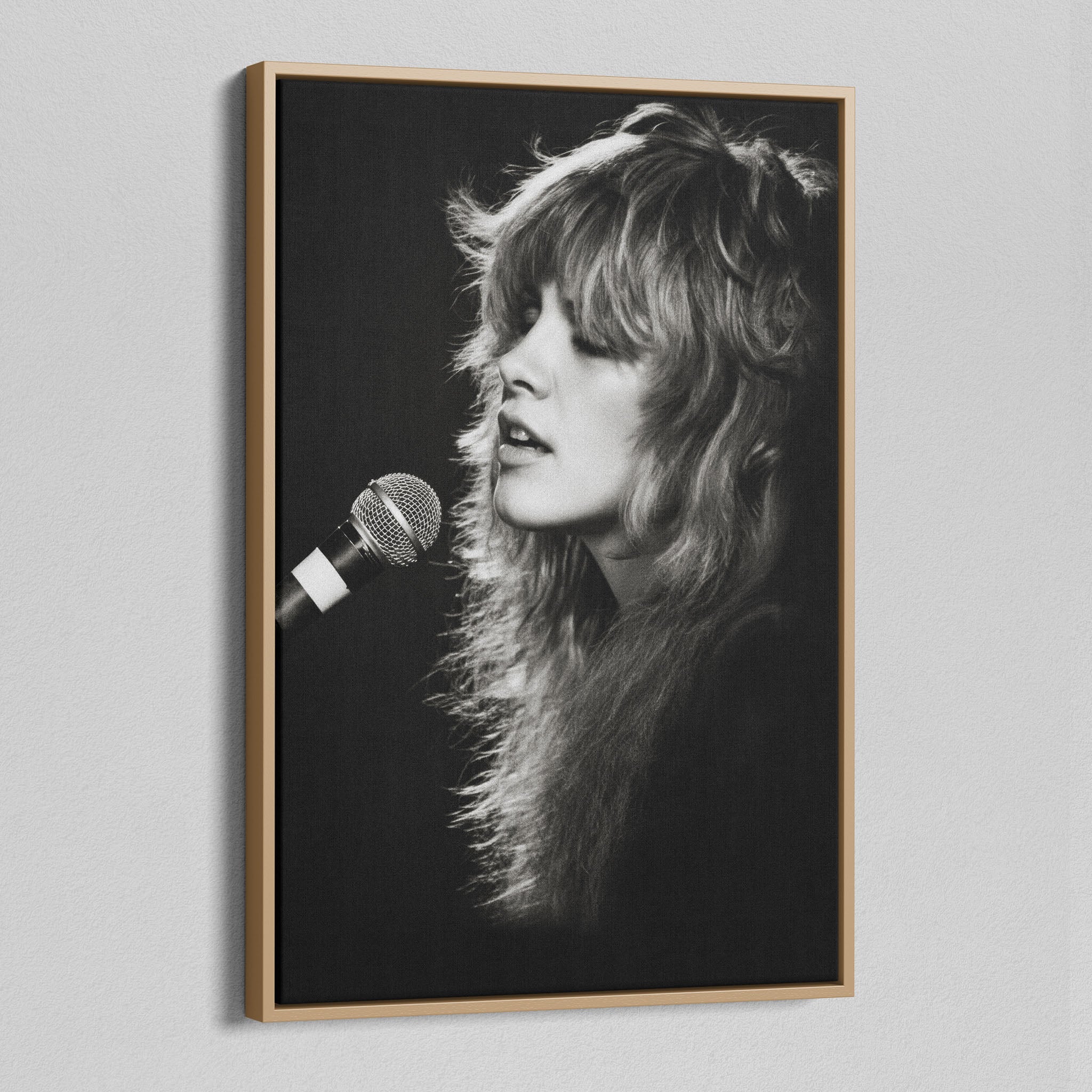 Angled view of the Stevie Nicks Rumours era black and white canvas in a natural oak floating frame