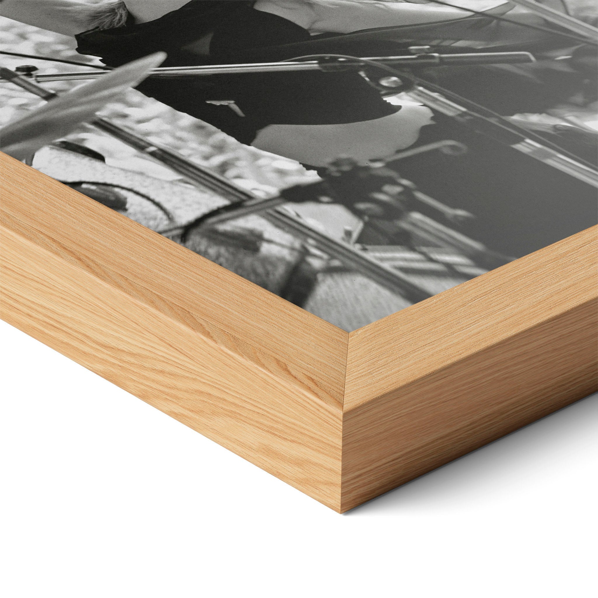 Corner close-up of the Stevie Nicks 1976 Oakland black and white poster in a natural oak frame