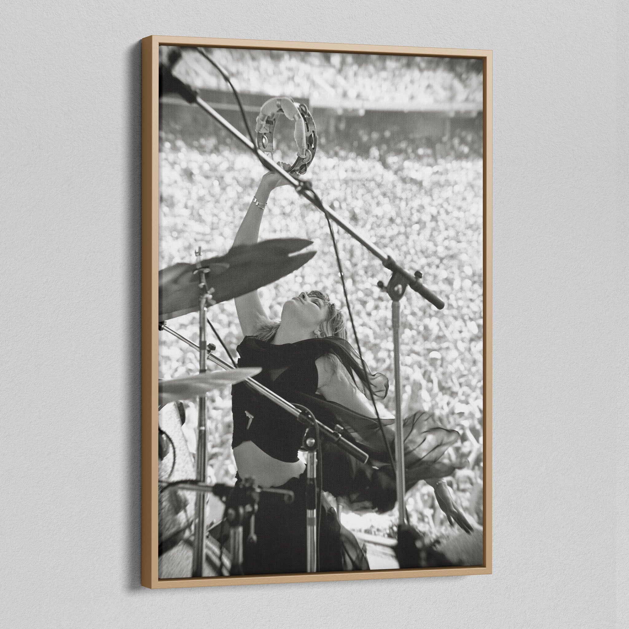 Angled view of the Stevie Nicks 1976 Oakland black and white canvas in a natural oak floating frame