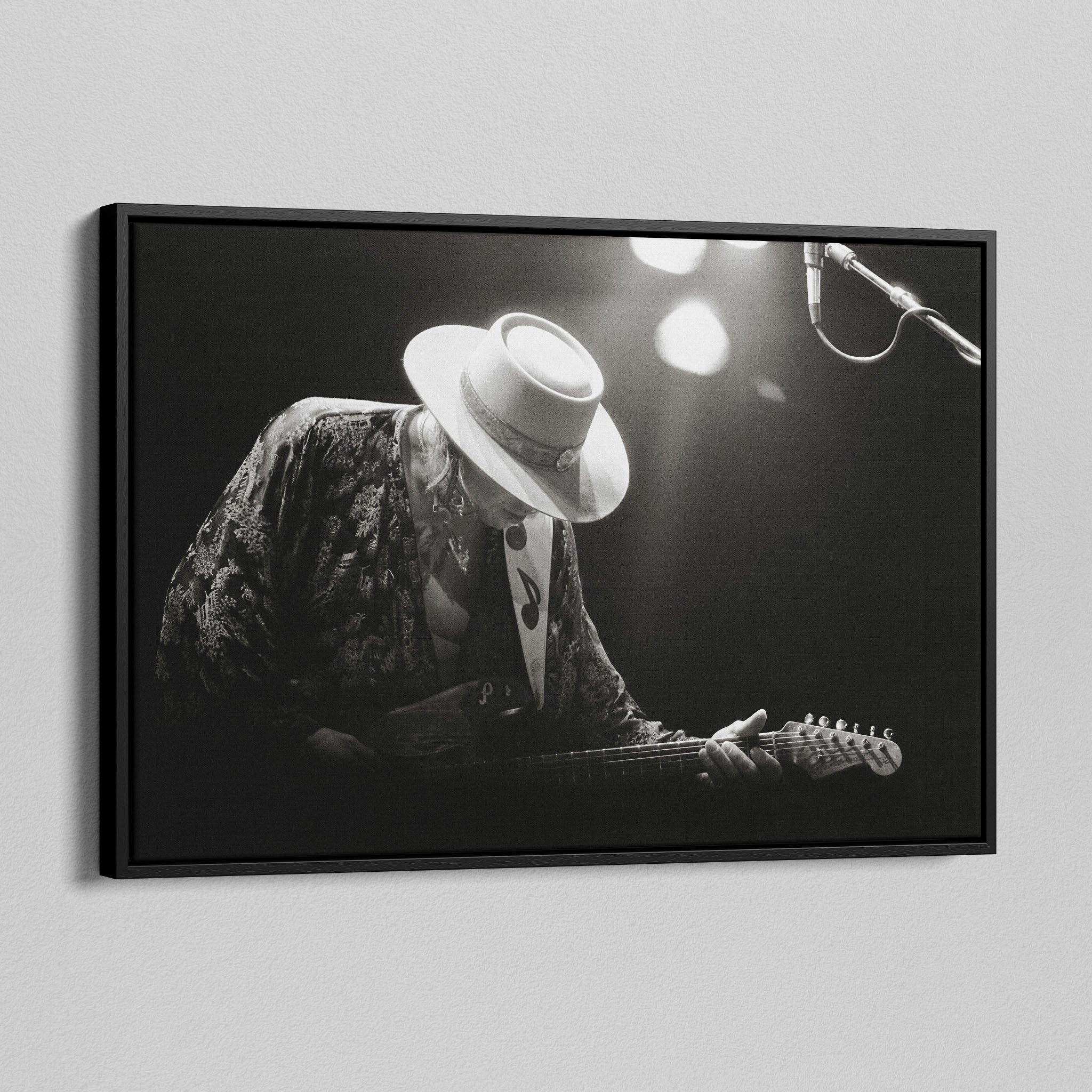 Angled view of the Stevie Ray Vaughan 1985 Laramie black and white canvas in a black floating frame