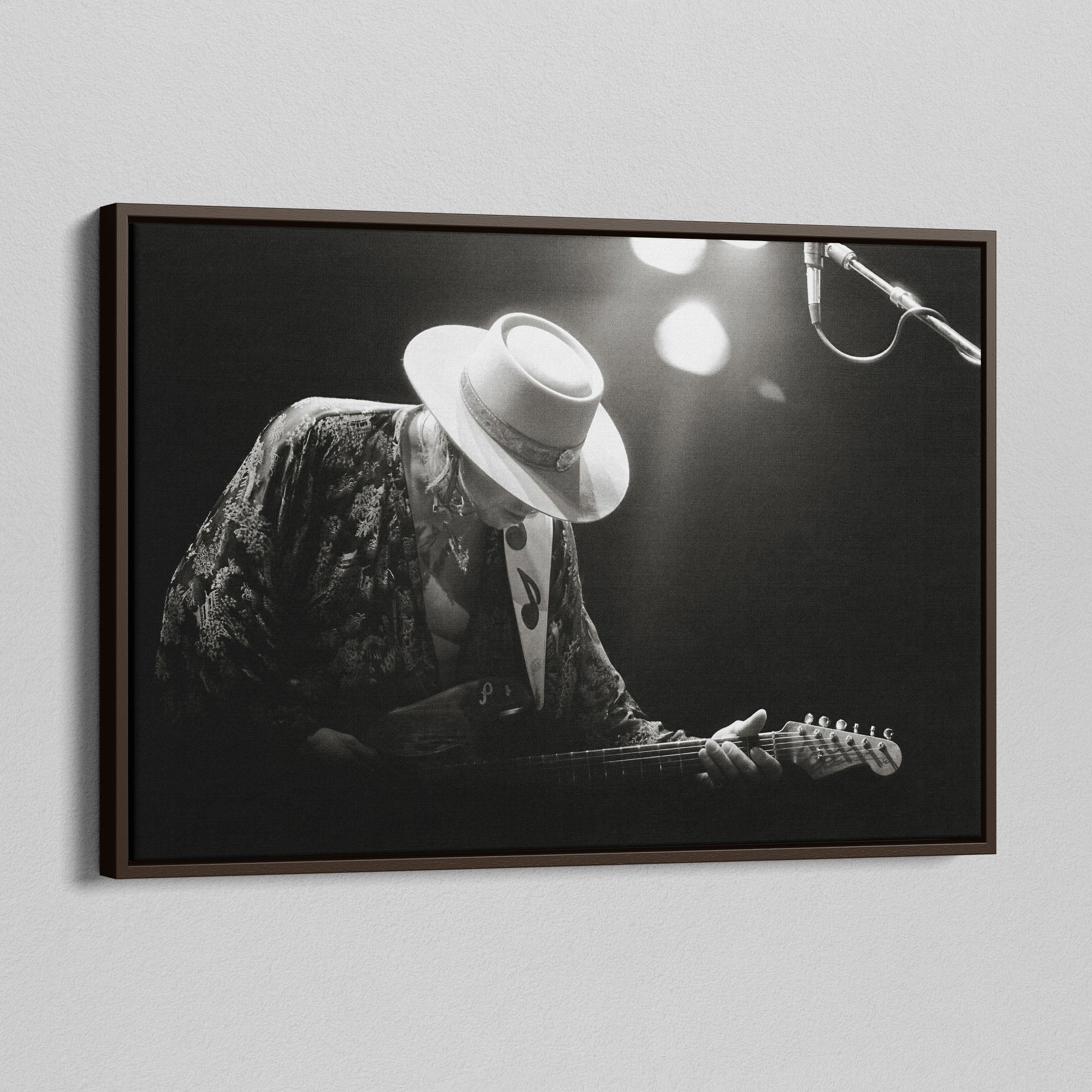Angled view of the Stevie Ray Vaughan 1985 Laramie black and white canvas in a dark walnut floating frame