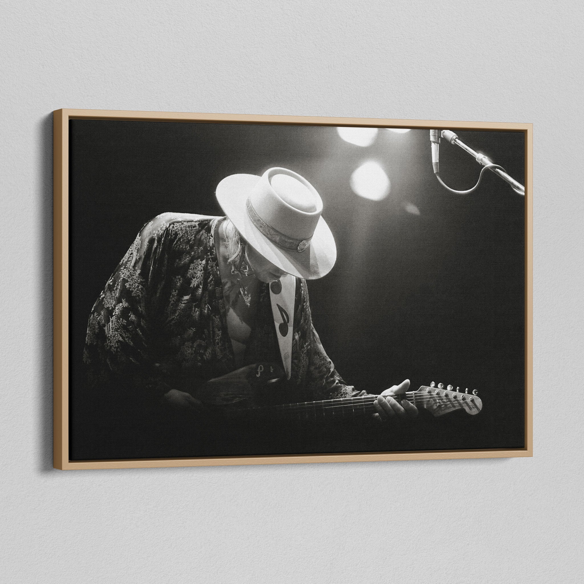 Angled view of the Stevie Ray Vaughan 1985 Laramie black and white canvas in a natural oak floating frame