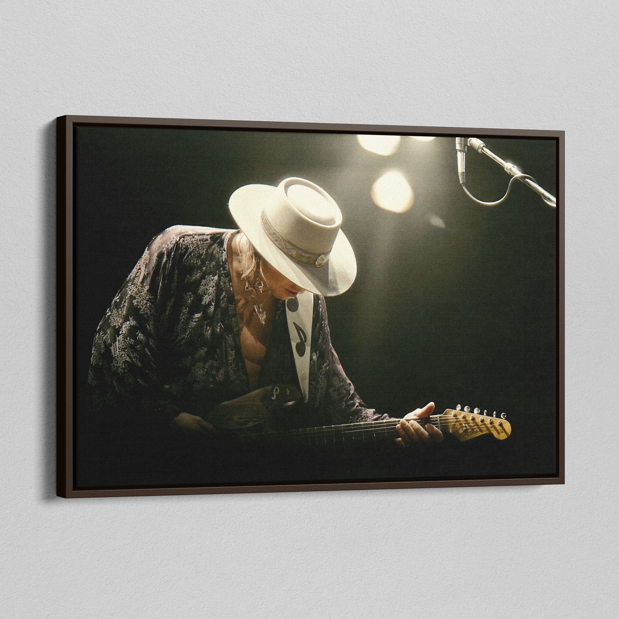 Angled view of the Stevie Ray Vaughan 1985 Laramie colorized canvas in a dark walnut floating frame