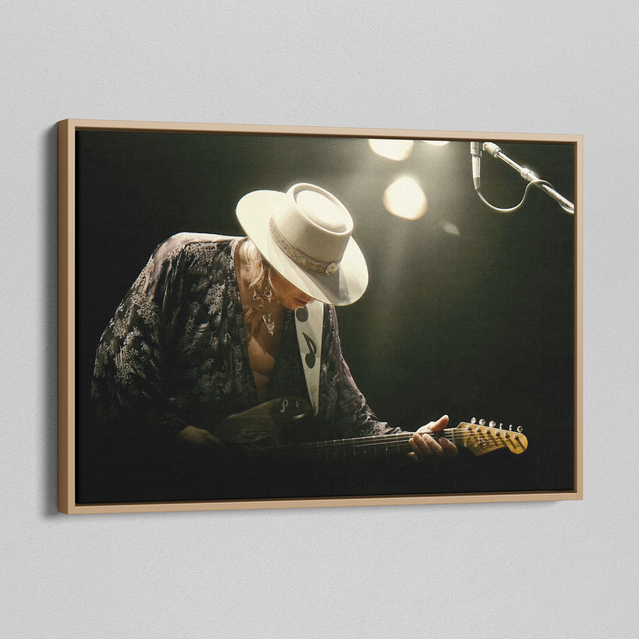Angled view of the Stevie Ray Vaughan 1985 Laramie colorized canvas in a natural oak floating frame