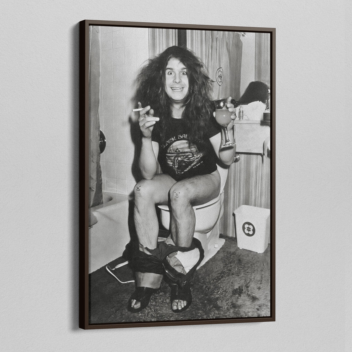 Angled view of the 1978 bathroom black and white canvas in a dark walnut floating frame