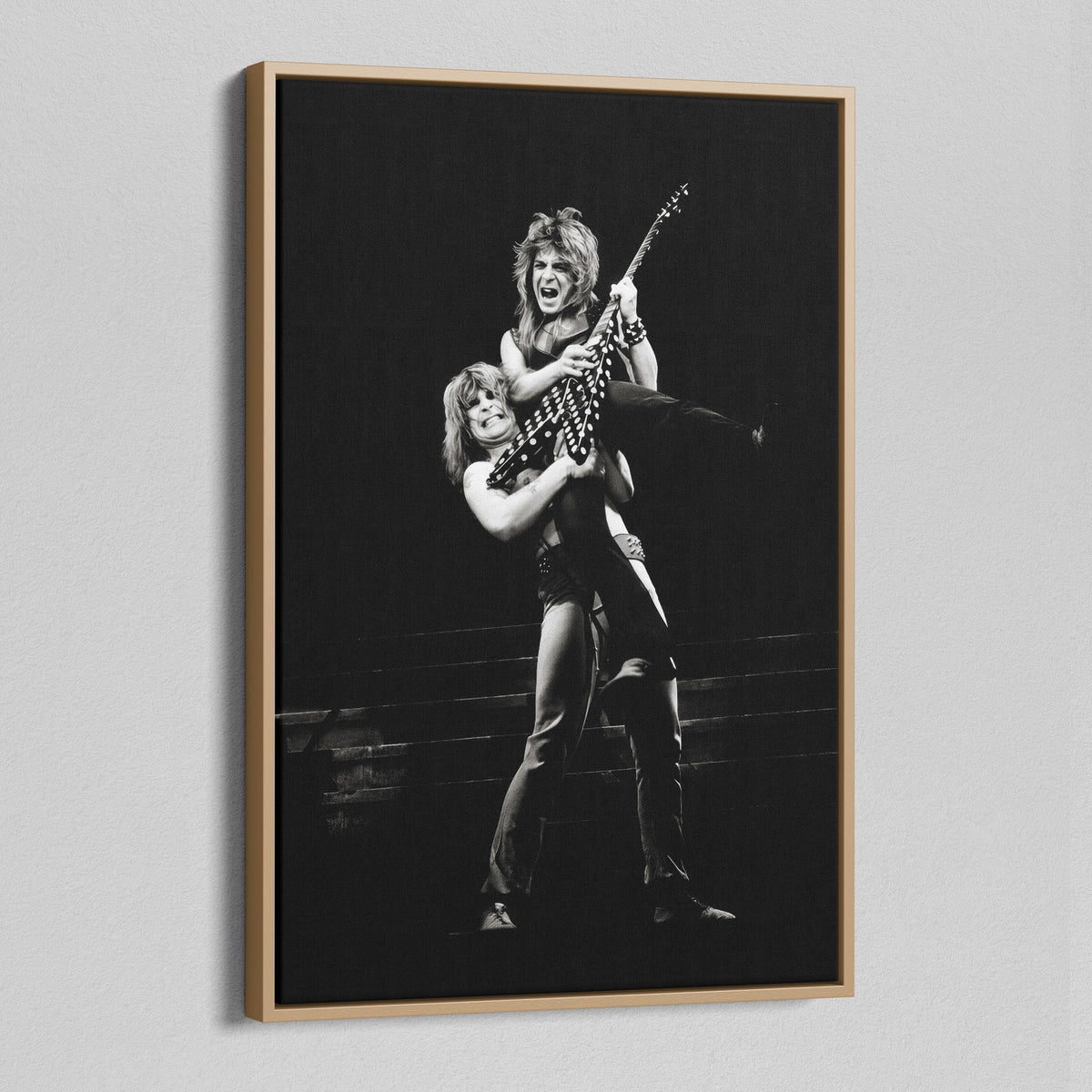 Angled view of the Randy Rhoads black and white canvas in a natural oak floating frame